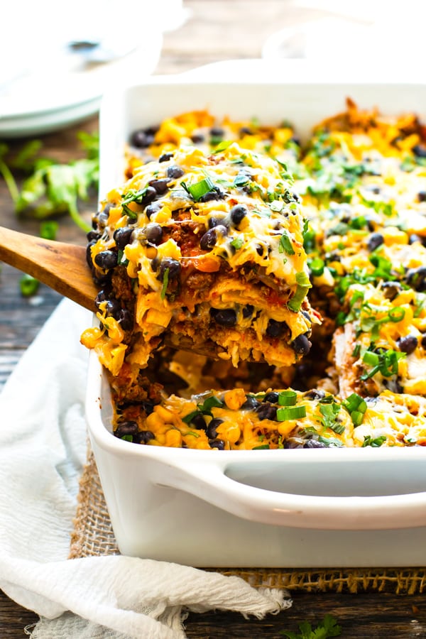 Ground Turkey Mexican Lasagna | A gluten free ground turkey Mexican lasagna made with corn tortillas and full of spices, bell peppers, onions, black beans, and cheese. It is a super easy and healthy kid-friendly weeknight dinner recipe!