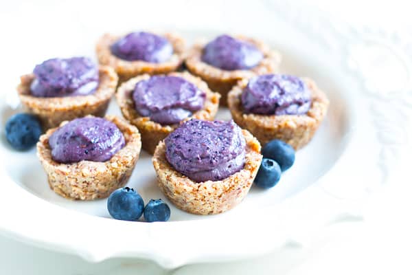 A collection of individual treats on a plate using a blueberry tart recipe.