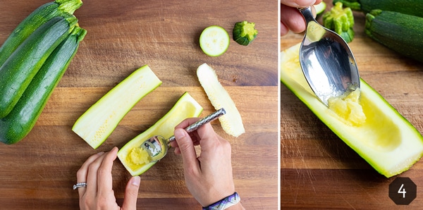Scooping out the inside flesh of a zucchini with a spoon.