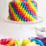Rainbow Birthday Cake | An impressive rainbow frosted cake that is perfect for any anniversary, birthday or special occasion. A classic vanilla cake recipe is finished off with multi-color buttercream frosting!