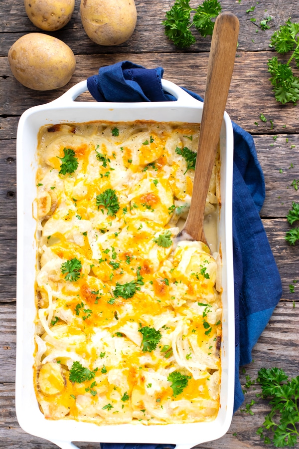 A white serving dish full of au gratin potatoes for Easter, Thanksgiving or Christmas.