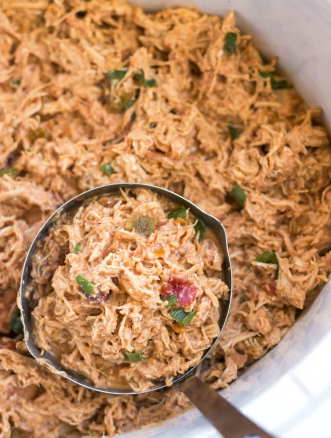 A ladle filled with Slow Cooker Salsa Shredded Chicken for an easy lunch.