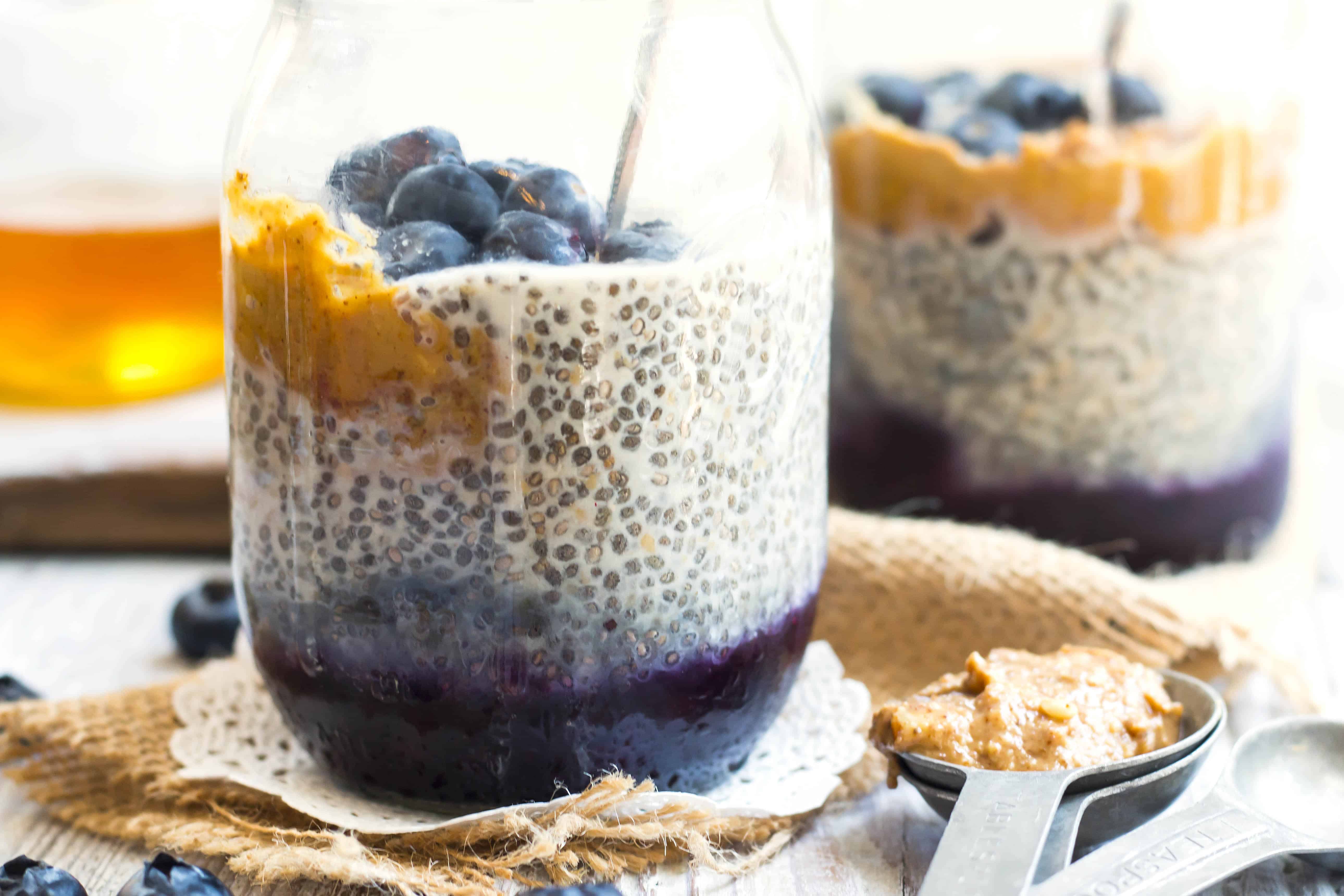 A jar filled with gluten-free chia seed pudding with peanut butter and jelly for a healthy breakfast.