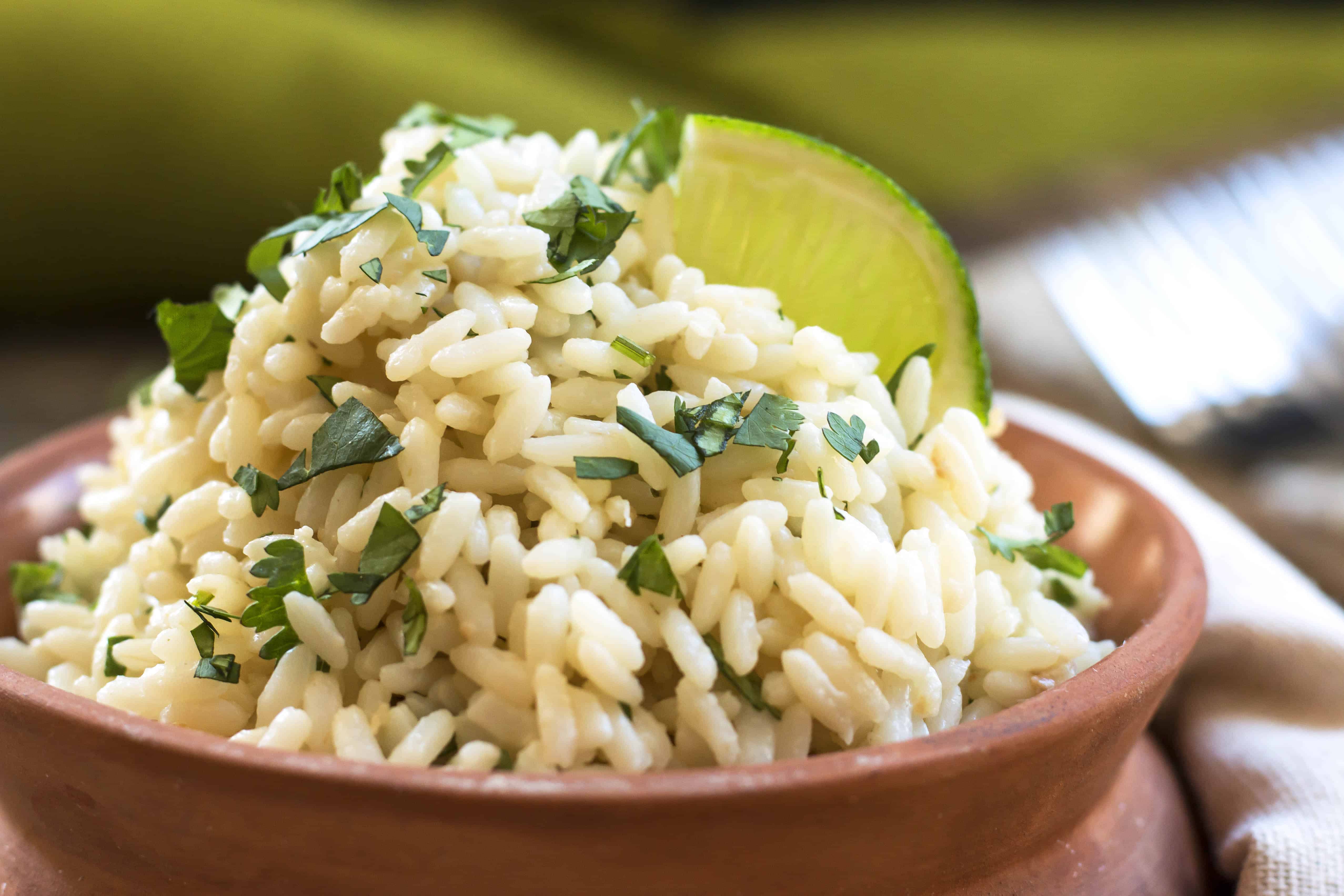 One bowl of coconut rice made in the rice cooker with lime.