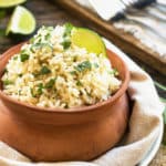 A clay bowl filled with gluten-free cilantro lime rice for a healthy side dish.