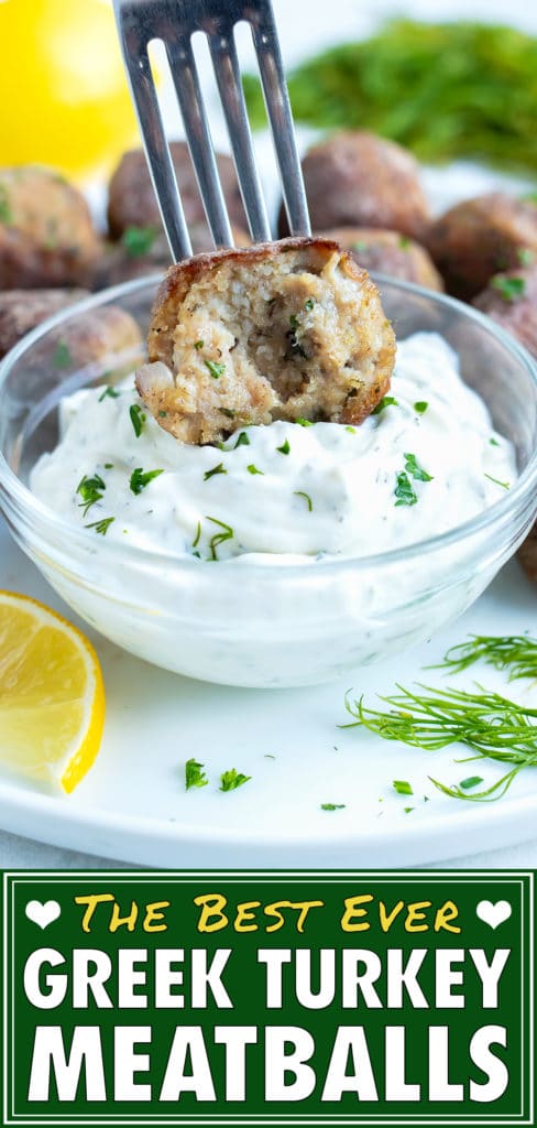 Greek meatballs are served on a plate with fresh lemon and a dipping sauce.