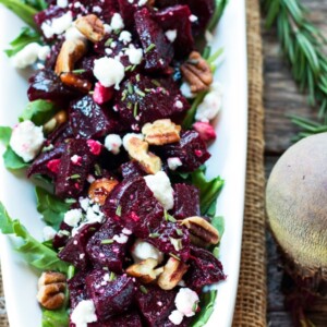 A tray filled with roasted beets, goat cheese, and pecans for an easy holiday side dish.