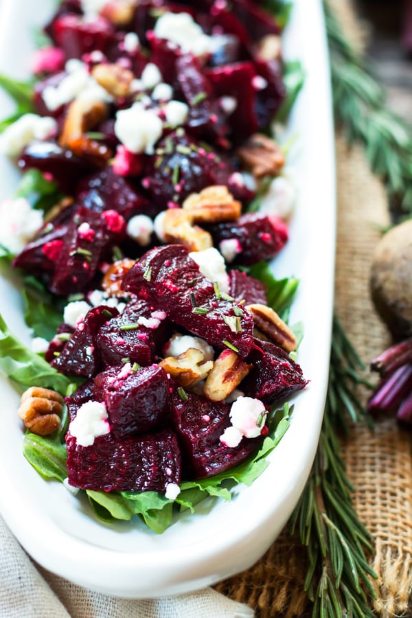 Twice Roasted Beets on a serving tray with goat cheese and herbs for a holiday celebration.