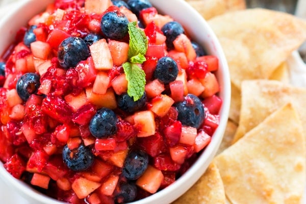 An overhead picture of cinnamon chips on the side and a bowl of Berry Fruit Salsa.