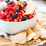 A plate with a bowl of Fruit Salsa and Sopapilla Chips for a healthy snack.