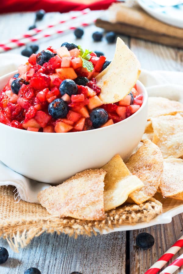 A plate with a bowl of Fruit Salsa and Sopapilla Chips for a healthy snack.