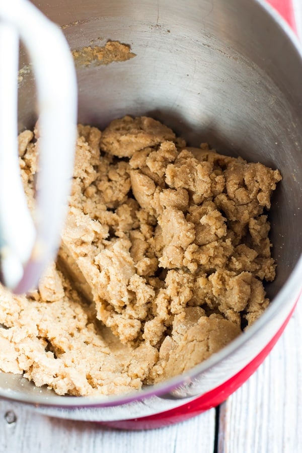 The ingredients for gluten-free homemade fig newtons being blended with an electric mixer.