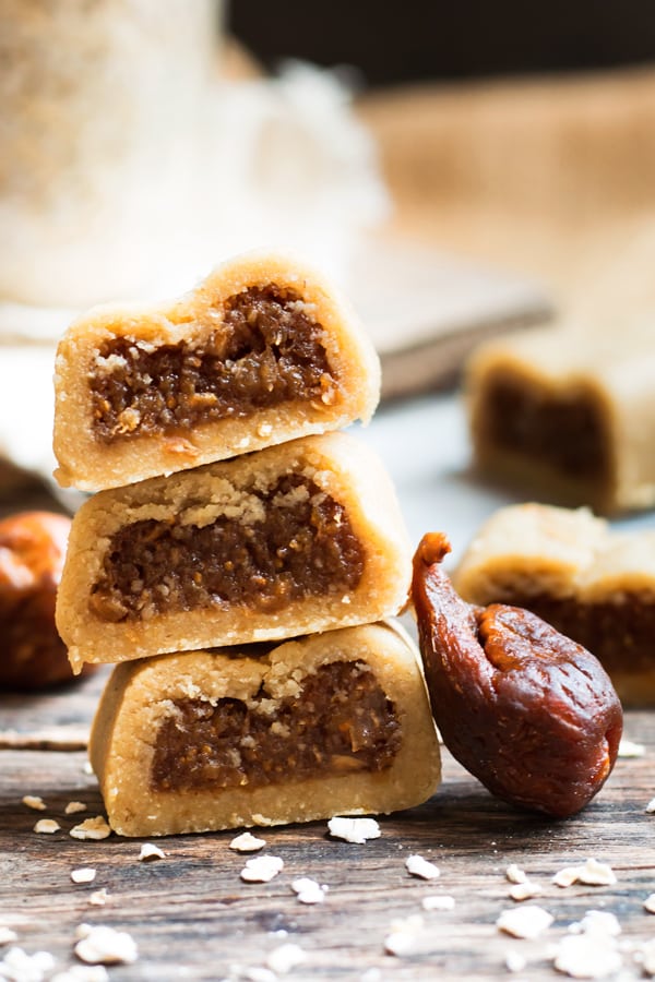 Three pieces of gluten-free fig newtons stacked into a pile for a healthy dessert.