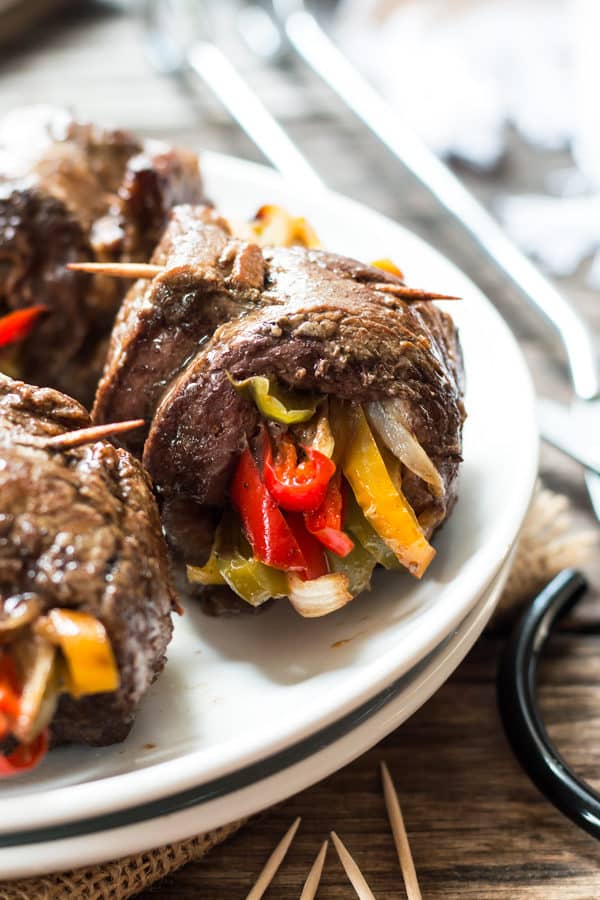 A healthy, gluten free dinner recipe for veggie and flank steak roll-ups. Cook these low-carb and Paleo steak roll-ups in a skillet or fire up the grill!