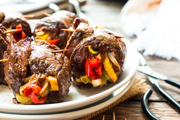 Balsamic Glazed Flank Steak & Veggie Roll-Ups | A healthy, gluten free dinner recipe for flank steak that is filled with roasted bell peppers and onions.