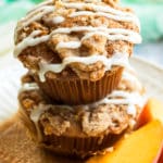 Gluten Free Peach Muffins with a Crumb Topping and Glaze | A breakfast muffin recipe that is bursting with fresh peaches, covered in a crumb topping and drizzled with a creamy glaze. Makes a wonderful sweet breakfast treat, afternoon snack or dessert!