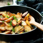 Cajun Skillet Potatoes {with Video} | A quick and easy gluten free side dish for potato wedges made in a skillet. Seasoned with chili powder and paprika!