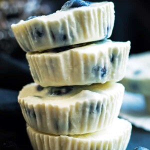A stack of four frozen yogurt bites using a blueberry and lemon recipe for a quick dessert.