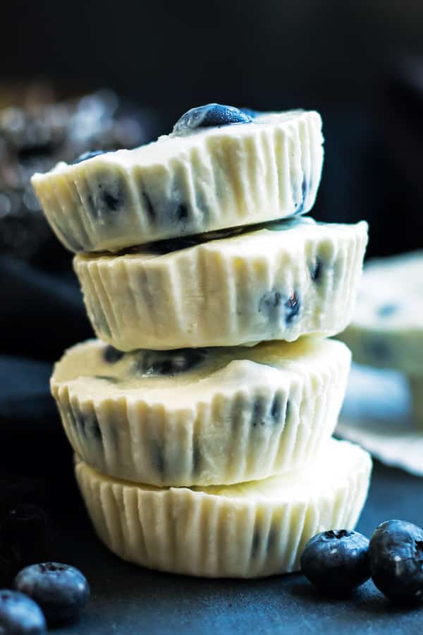 A stack of four frozen yogurt bites using a blueberry and lemon recipe for a quick dessert.