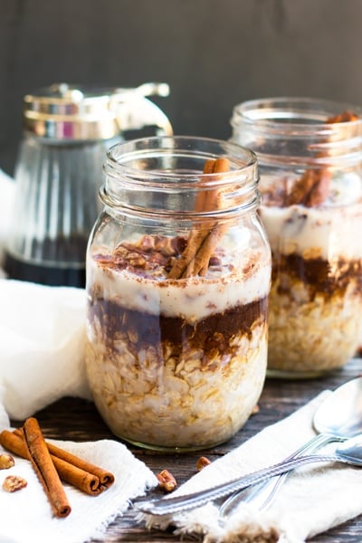 Two jars of gluten-free overnight oats made with maple, brown sugar, and cinnamon for a healthy breakfast.