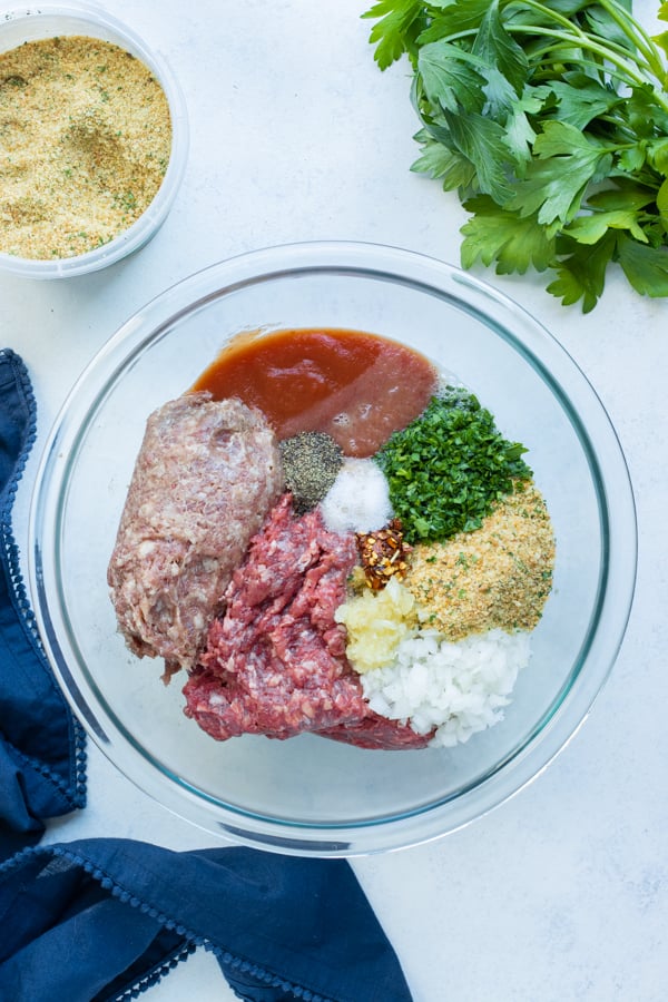 All the meatloaf ingredients are mixed together in a bowl.