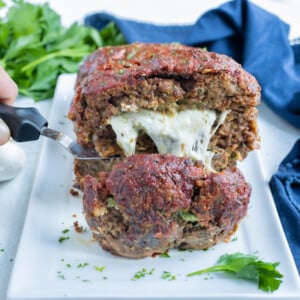 Stuffed meatloaf is shown with a gooey mozzarella center.