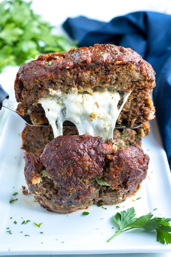 Mozzarella cheese is shown inside a flavorful meatloaf.