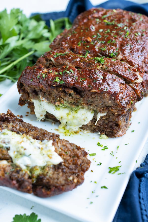 Stuffed meatloaf is shown with a gooey mozzarella center.