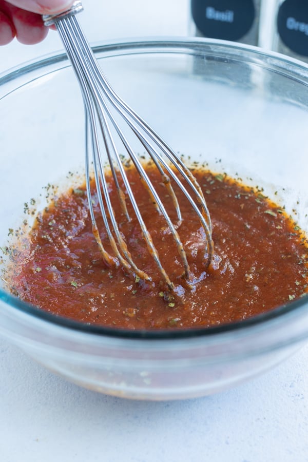 Tomato sauce, parley, seasoning is mixed in a bowl for the special glaze.