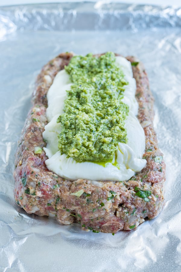 Meatloaf, mozzarella, and then pesto are layered on top of each other.