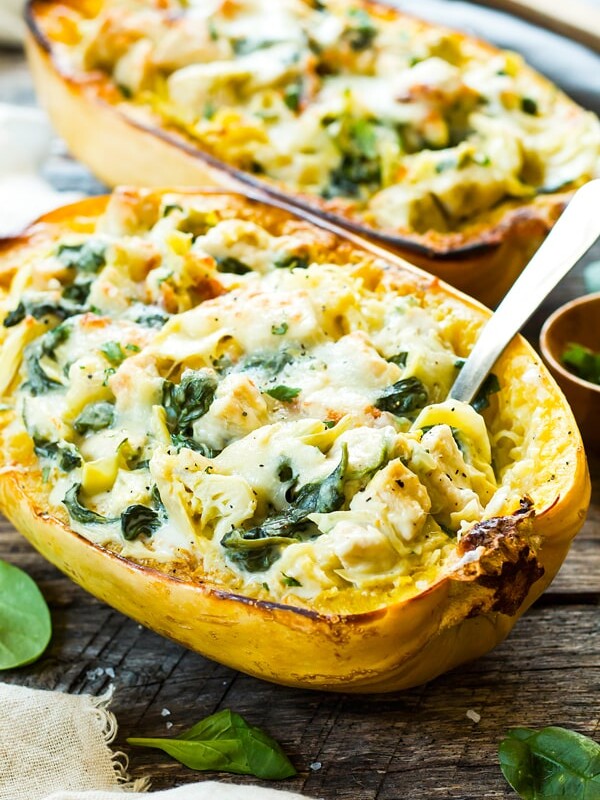 Two squash boats filled with a gluten-free spaghetti squash recipe for an easy weeknight dinner.