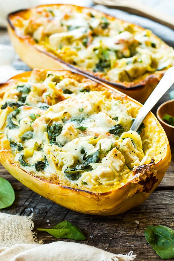 Two squash boats filled with a gluten-free spaghetti squash recipe for an easy weeknight dinner.