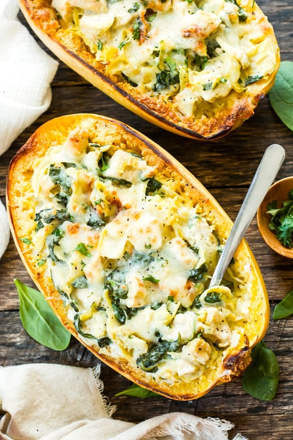 An overhead picture of two Spinach Artichoke Spaghetti Squash Boats with chicken for a healthy lunch.