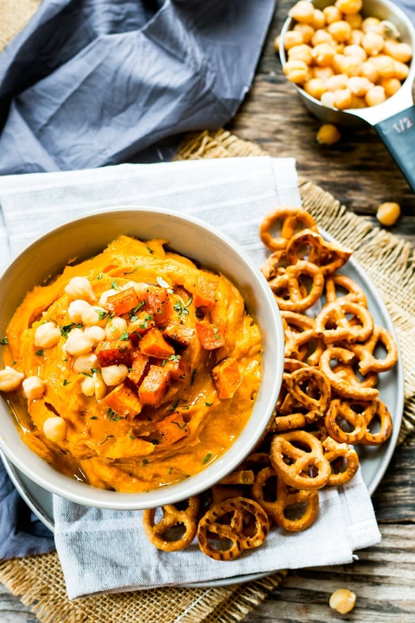 A bowl filled with gluten-free homemade hummus made with roasted sweet potatoes for a healthy appetizer.