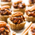 Pecan Pie Mini Tarts on parchment paper ready for the holidays.