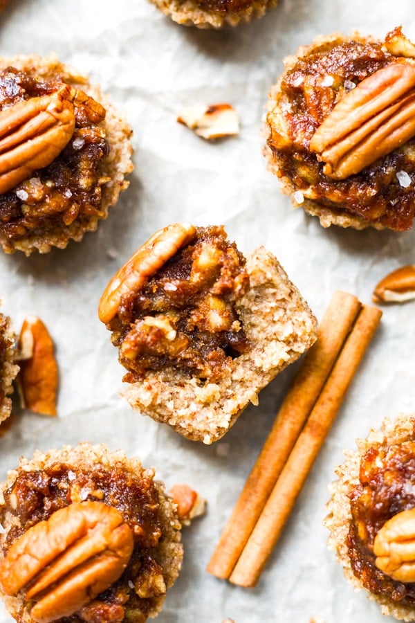 Gluten-free pecan pie tarts on parchment paper for Thanksgiving.