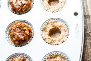 Gluten-free pecan tarts in a muffin tin for a delicious holiday dessert.