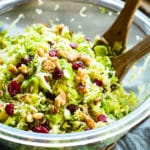 Gluten-free Shredded Brussel Sprouts recipe in a bowl with two wooden serving spoons.