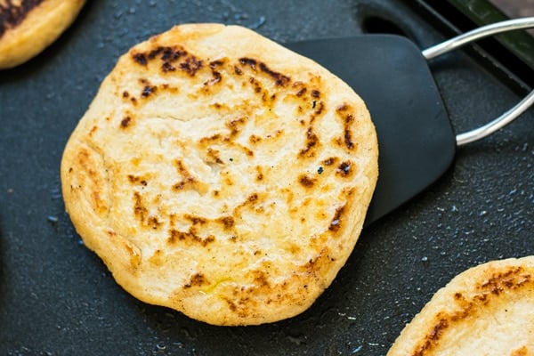 An overhead picture of an arepa recipe on a spatula to make delicious sandwiches.