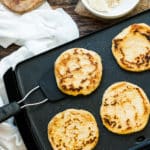 A spatula lifting up a gluten-free arepa made with masarepa for an easy meal.