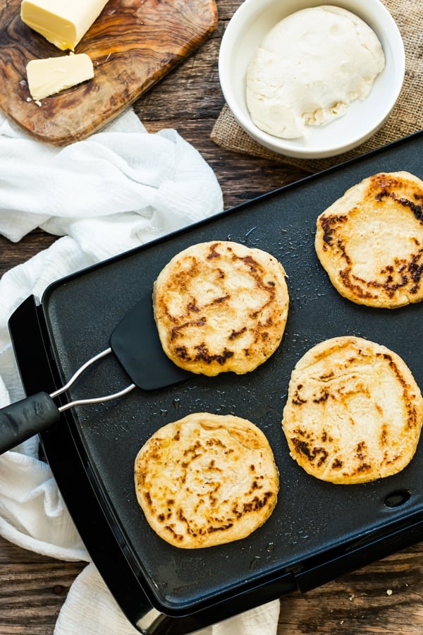 A spatula lifting up a gluten-free arepa made with masarepa for an easy meal.