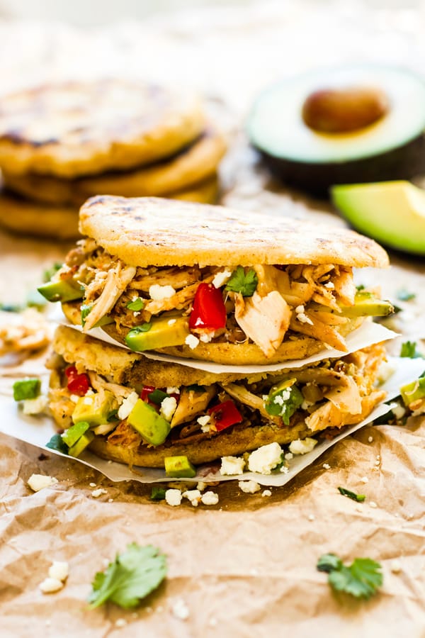 Two Chicken and Avocado Stuffed Arepas stacked on top of each other for a quick dinner.