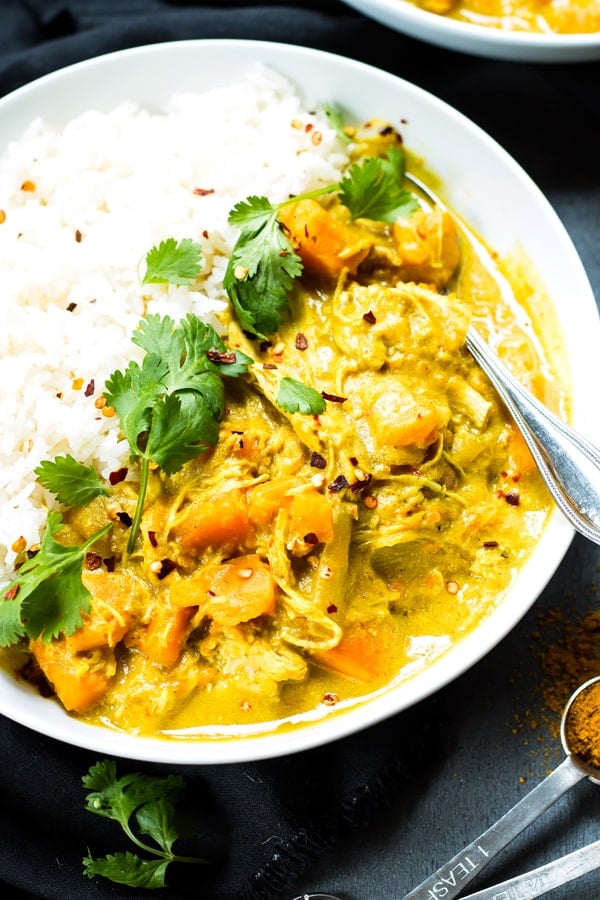 A bowl filled with gluten-free chicken curry with coconut milk ready to eat for dinner.