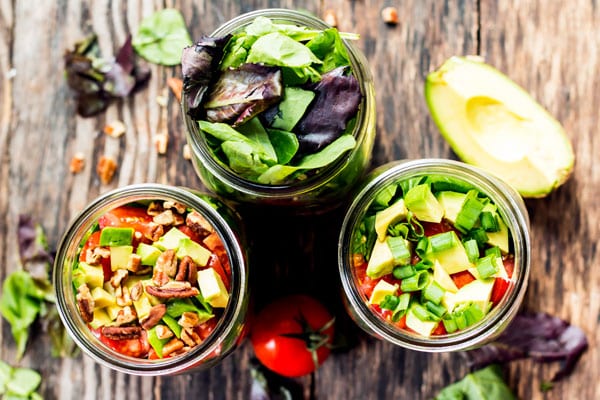 An overhead picture of three gluten-free salads in a jar for a delicious lunch.