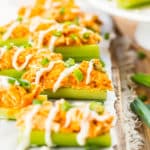 A collection of Buffalo Chicken Celery Sticks with ranch dressing drizzled on top.