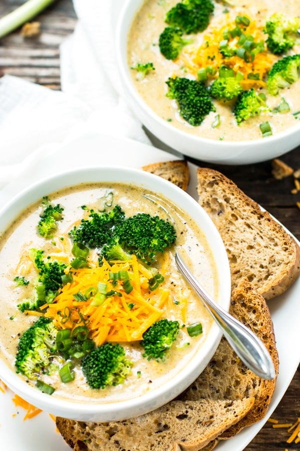 Two bowls filled with a slow cooker broccoli cheese soup recipe for a light dinner.