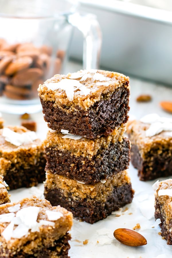 Three German Chocolate Bars in a pile surrounded by almonds.