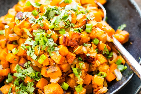 Gluten-free skillet potatoes recipe in a bowl with a spoon for a delicious side dish.