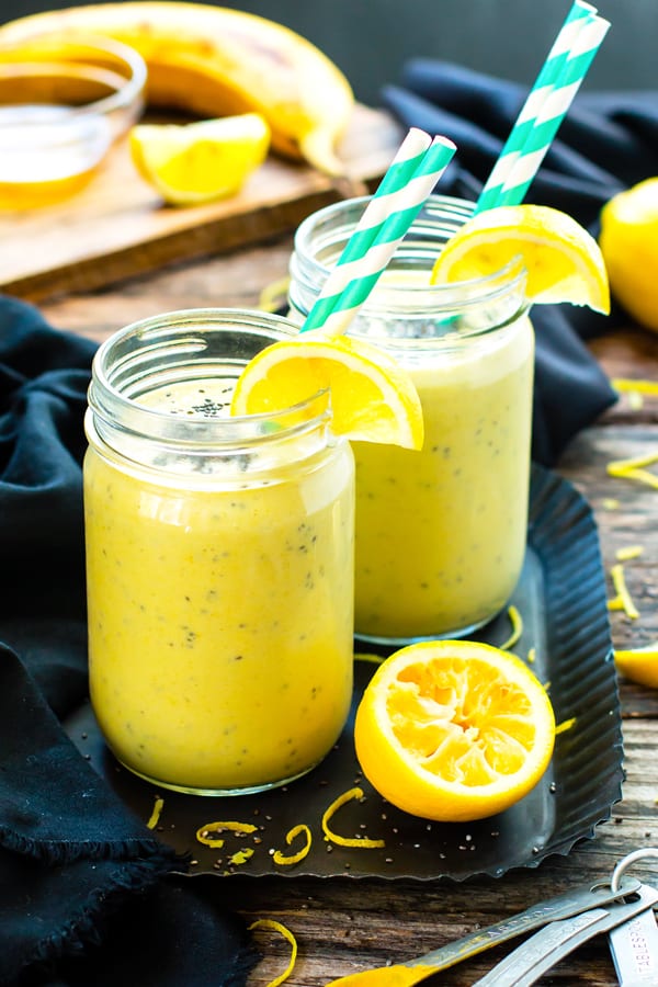 Two smoothies made with lemon and chia seeds on a black serving tray for a healthy treat.