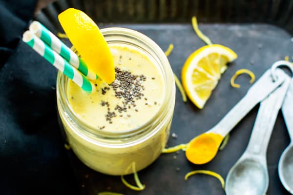 A glass full of a lemon smoothie using turmeric and chia seeds.